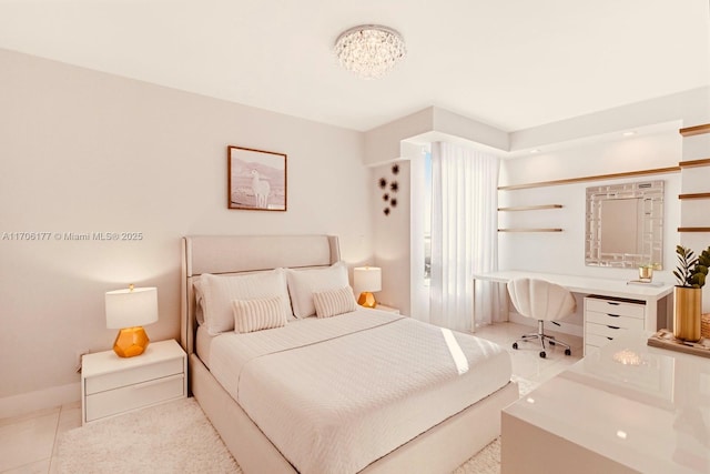 bedroom featuring light tile patterned floors and baseboards