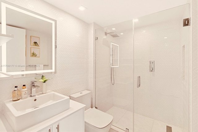 bathroom with toilet, vanity, tile walls, backsplash, and a shower stall