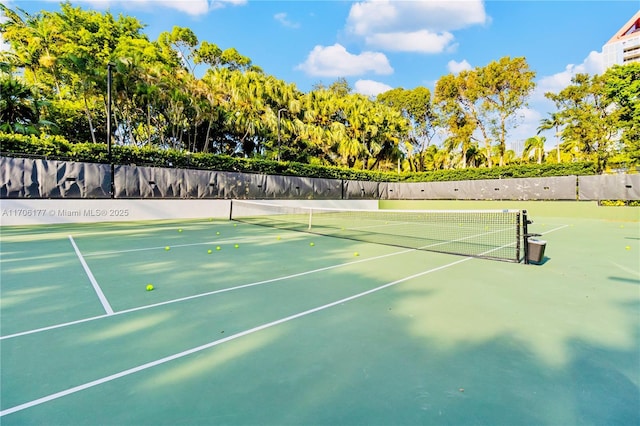 view of tennis court with fence