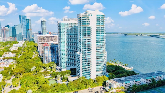 birds eye view of property with a water view and a city view