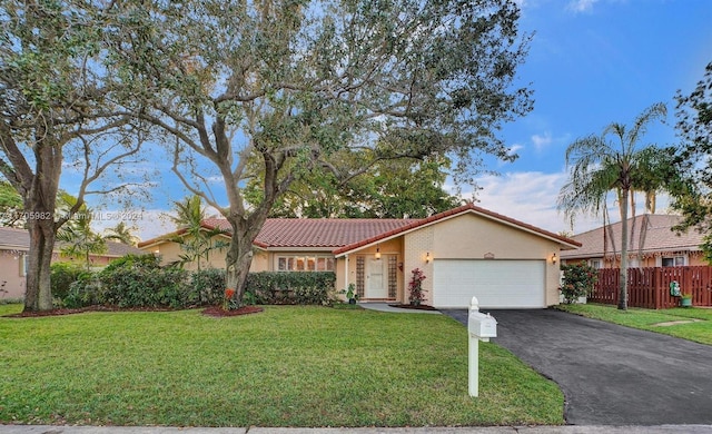 view of front of home featuring a front yard and a garage