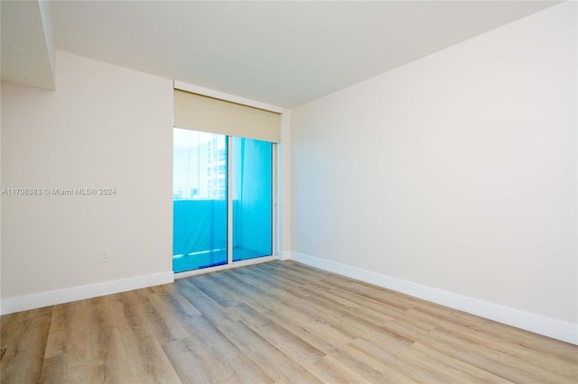 unfurnished room with light hardwood / wood-style floors