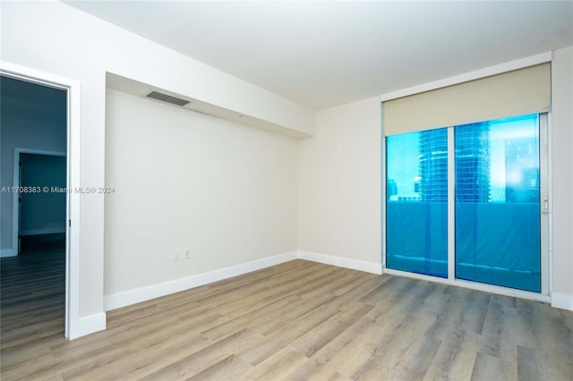 spare room featuring light wood-type flooring