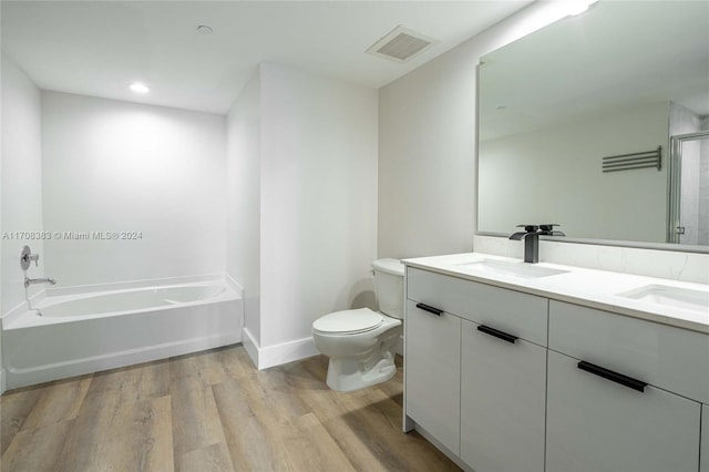 full bathroom with wood-type flooring, vanity, toilet, and independent shower and bath