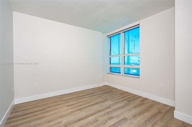 unfurnished room with light wood-type flooring