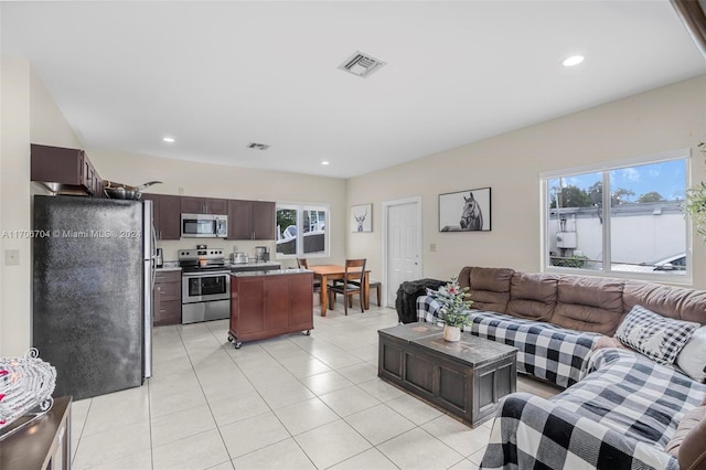 living room with light tile patterned floors and a wealth of natural light