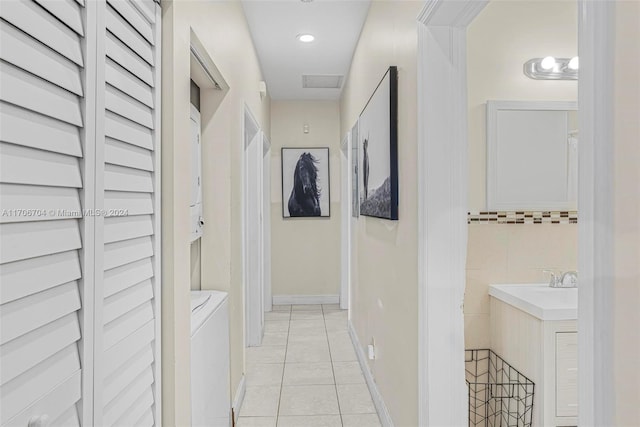 hall featuring light tile patterned floors