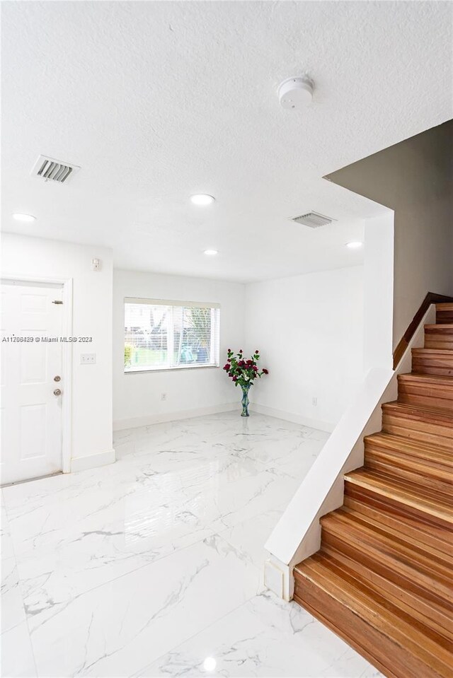 17921 SW 140th Ct Unit 17921, Miami, FL 33177 - stairway featuring marble tiled flooring, recessed lighting, and a textured ceiling