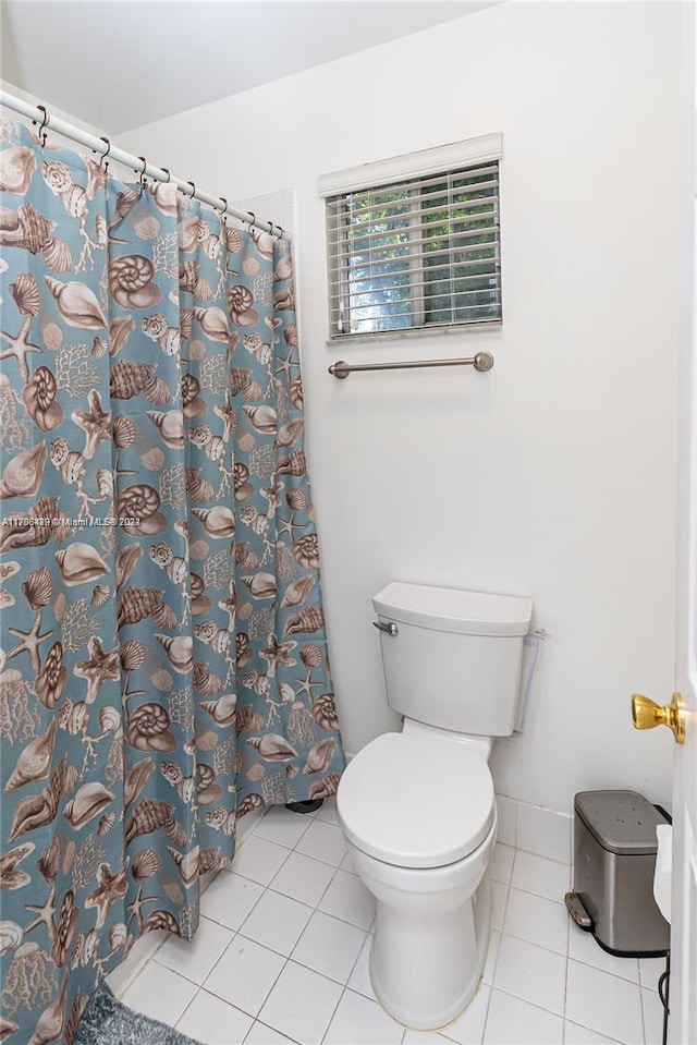 bathroom with tile patterned flooring and toilet