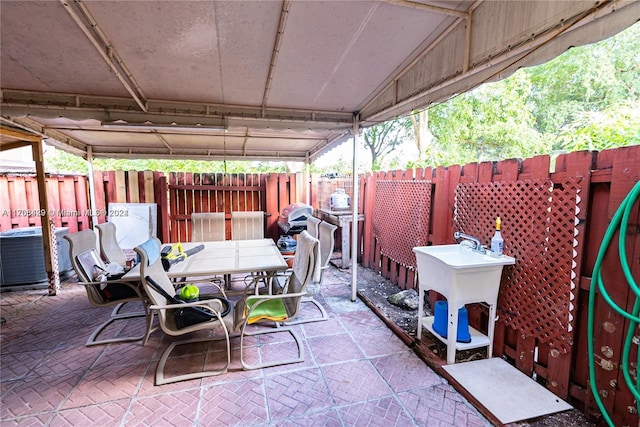 view of patio / terrace featuring cooling unit and sink