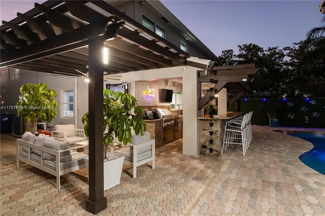 patio terrace at dusk with a pergola, grilling area, area for grilling, and an outdoor bar