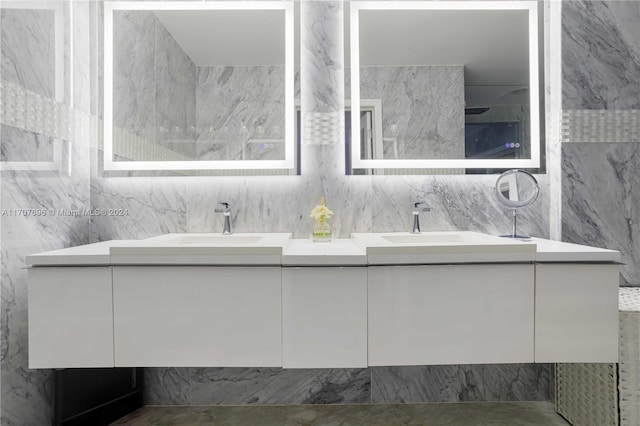 bathroom with vanity and tile walls