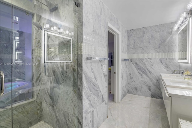 bathroom featuring vanity, a shower with shower door, and tile walls