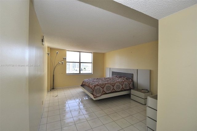 tiled bedroom with a textured ceiling