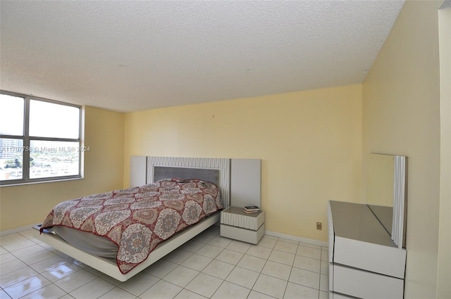 tiled bedroom with a textured ceiling