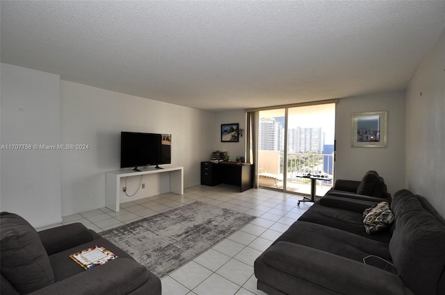 living room featuring a textured ceiling and light tile patterned flooring