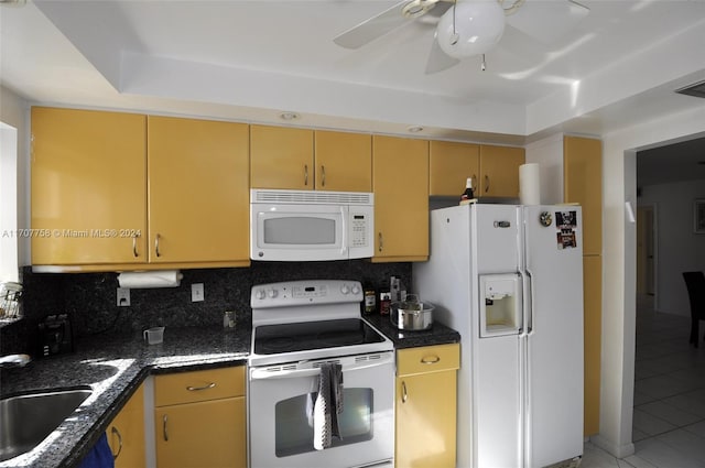 kitchen featuring ceiling fan, sink, tile patterned flooring, backsplash, and white appliances