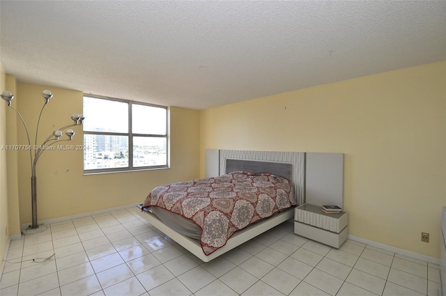 bedroom with light tile patterned floors and a textured ceiling