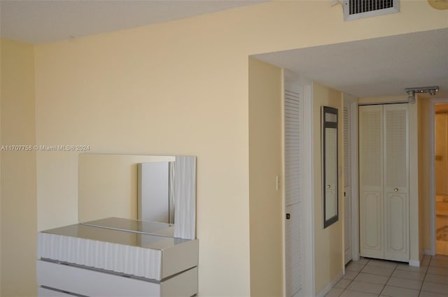 hall featuring light tile patterned flooring