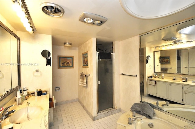 bathroom with shower with separate bathtub, vanity, and tile patterned floors