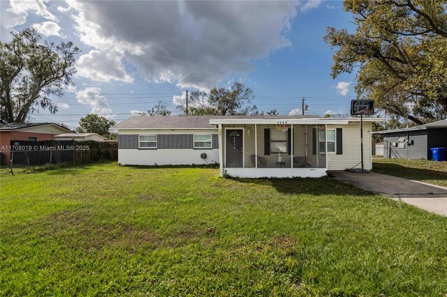 ranch-style home featuring a front lawn and a sunroom