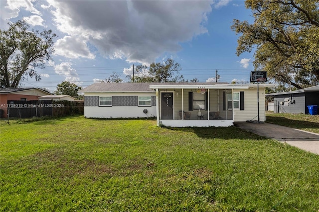 view of front facade with a sunroom and a front yard