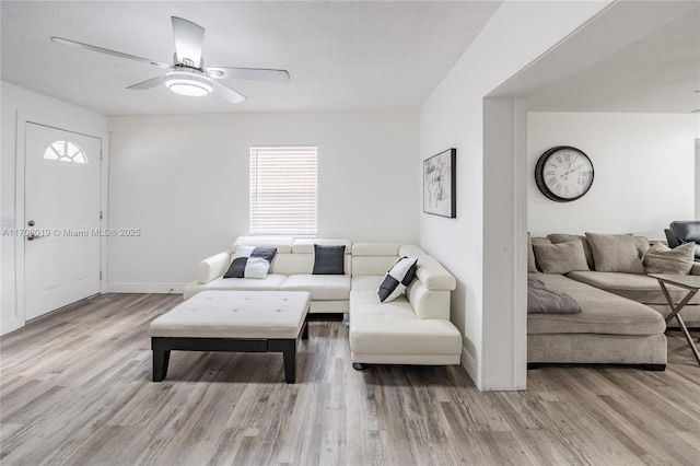 living room featuring hardwood / wood-style flooring, a healthy amount of sunlight, and ceiling fan