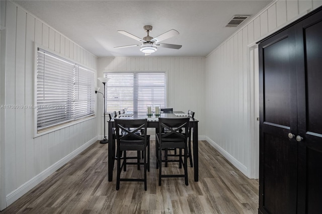 dining area featuring ceiling fan and wood-type flooring