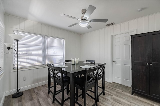 dining area with ceiling fan and light wood-type flooring