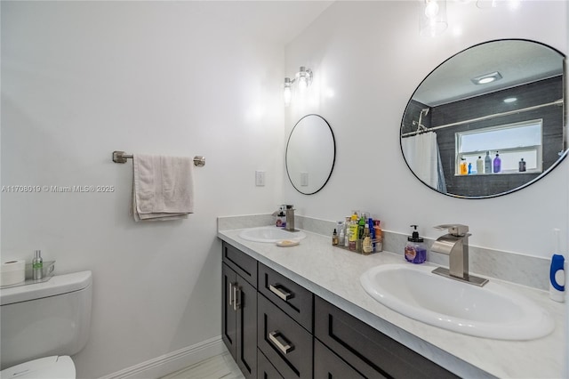 bathroom featuring vanity, walk in shower, and toilet