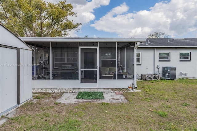 back of property featuring central AC, a sunroom, and a lawn