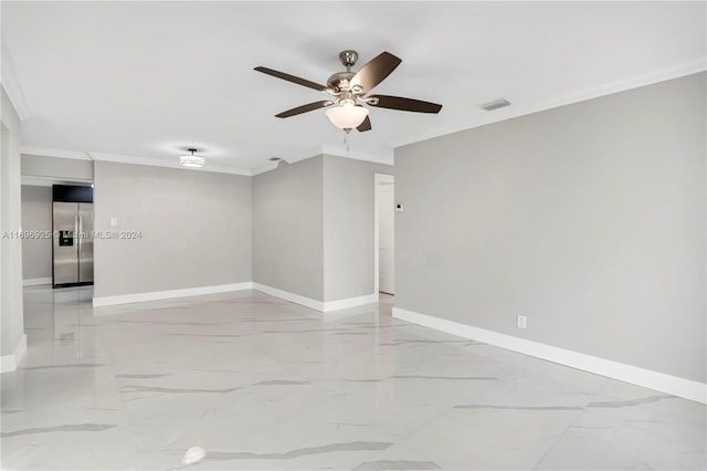 spare room featuring ceiling fan and ornamental molding