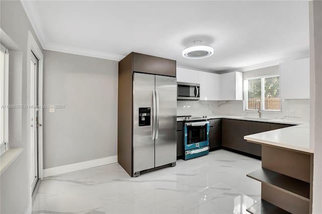 kitchen featuring backsplash, white cabinets, crown molding, sink, and stainless steel appliances