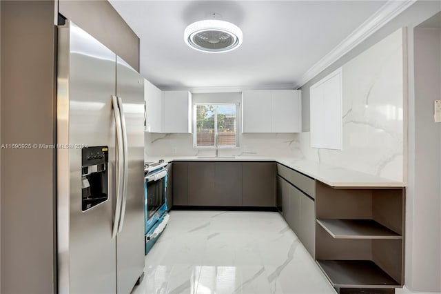 kitchen with white cabinets, sink, crown molding, appliances with stainless steel finishes, and tasteful backsplash