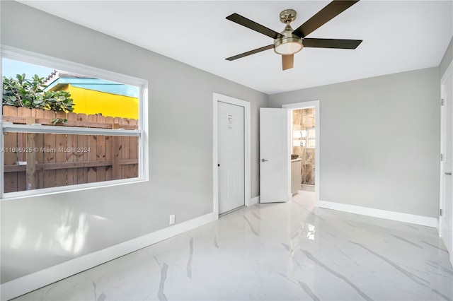 unfurnished bedroom featuring connected bathroom and ceiling fan