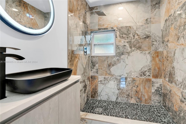 bathroom featuring vanity and tiled shower