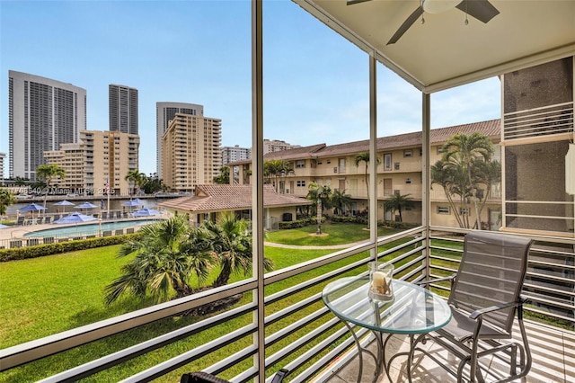 balcony with a ceiling fan and a city view