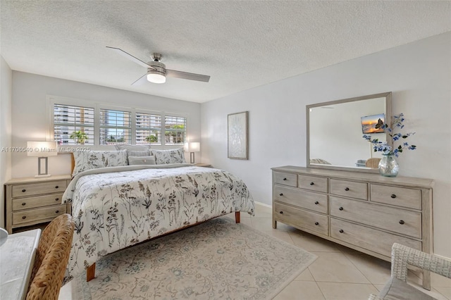 bedroom featuring light tile patterned floors, a textured ceiling, and a ceiling fan