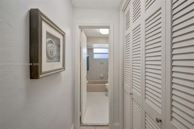 hallway with tile patterned flooring