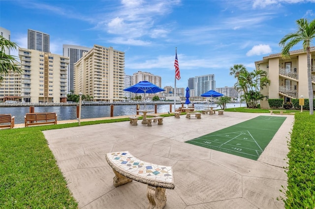 view of community featuring shuffleboard, a water view, and a city view