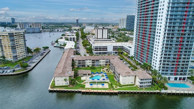 birds eye view of property featuring a city view and a water view