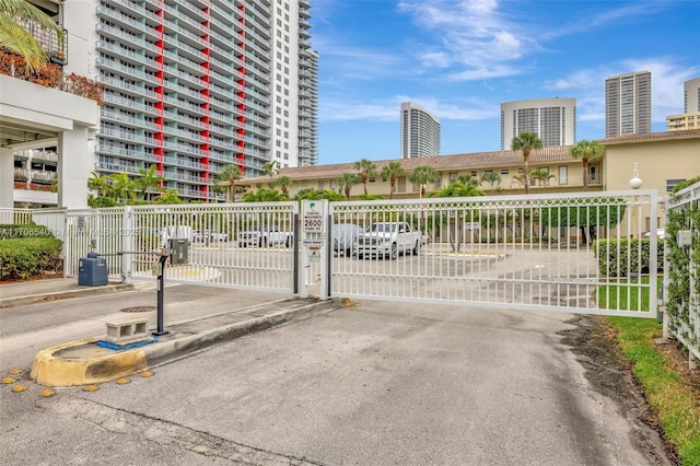 view of gate featuring a view of city and fence