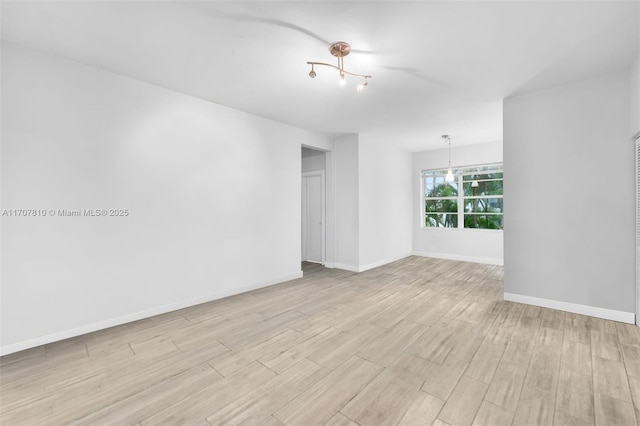 spare room with light hardwood / wood-style flooring