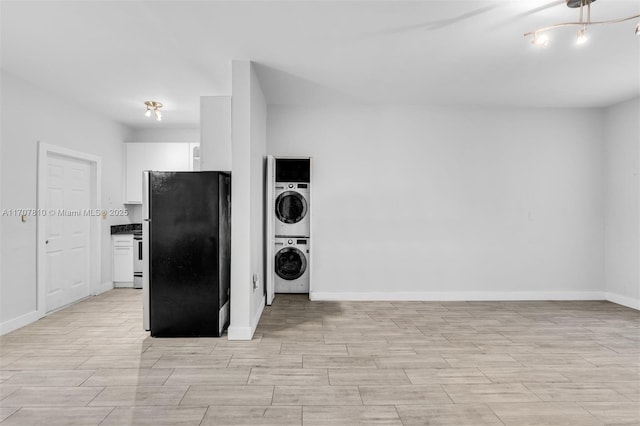 laundry area featuring stacked washer / dryer