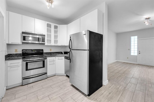 kitchen featuring sink, stainless steel appliances, and white cabinets