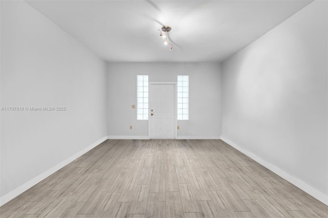 empty room with light hardwood / wood-style flooring