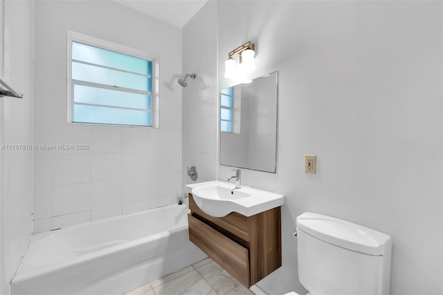 full bathroom featuring tiled shower / bath, vanity, and toilet