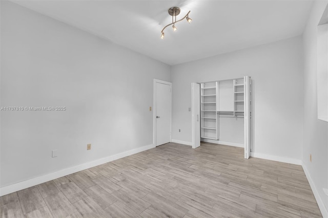 unfurnished bedroom with light wood-type flooring