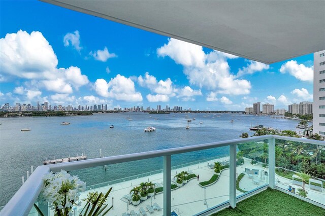 balcony featuring a view of city and a water view