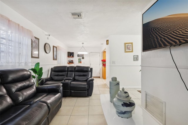 living room with light tile patterned floors and a textured ceiling